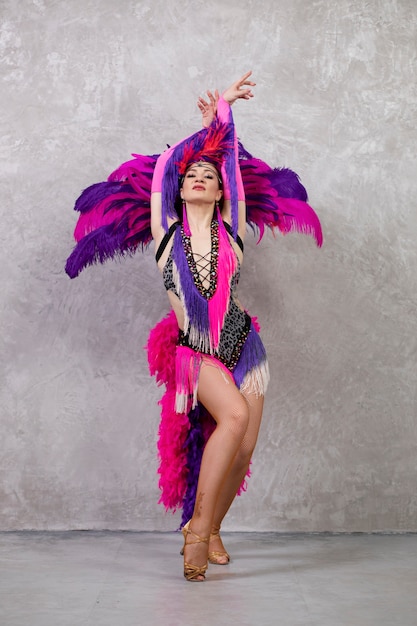 Female cabaret performer posing in feathers costume