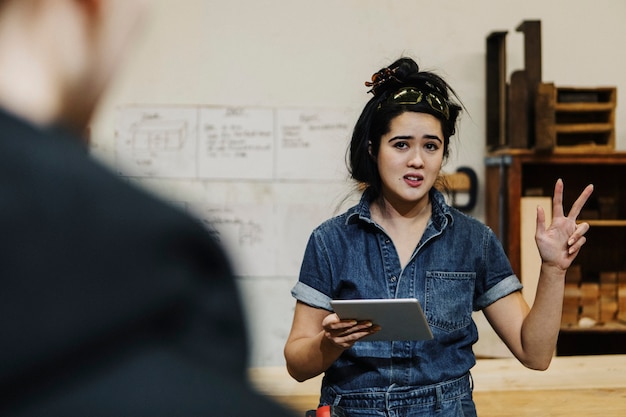 Female carpenter briefing a project to team