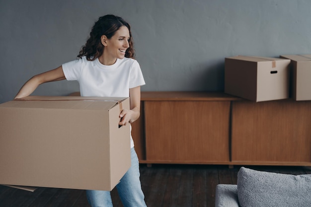 Female carrying cardboard box to room on moving day mortgage\
tenancy parcel delivery service ad