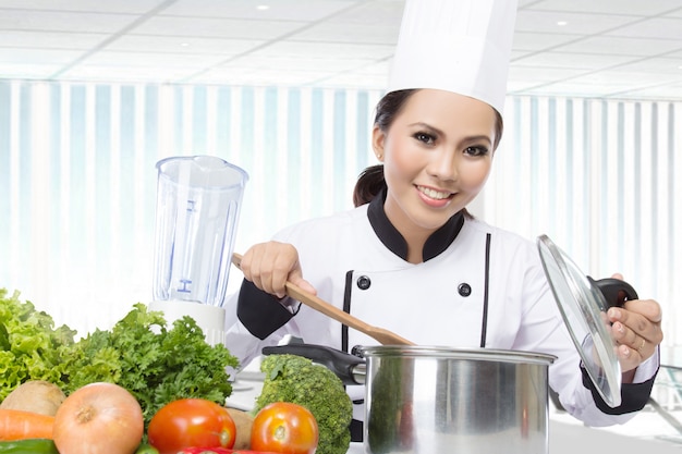 Female chef cooking in the kitchen