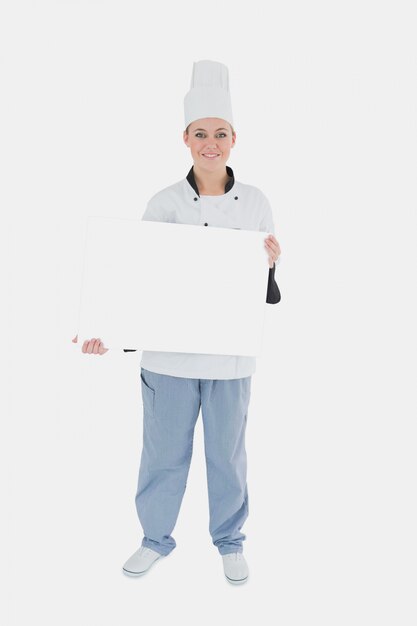 Female chef holding billboard