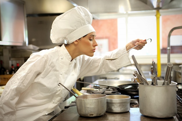 Female chef tasting