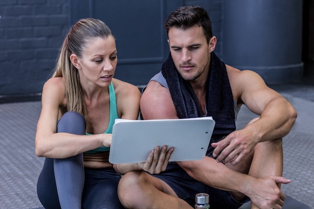 A female coach explaining directives with clipboard