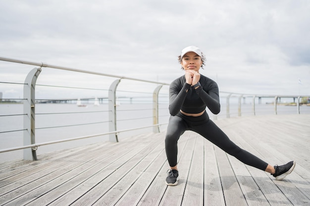 A female coach is actively engaged in sports runs in the city uses a smartwatch