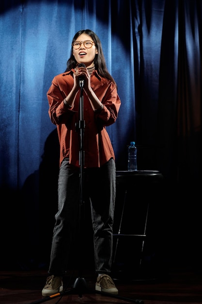 Female comedian standing on stage