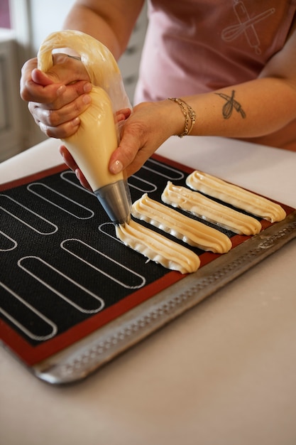 Photo female confectioner baking with dough in a pastry shop