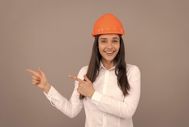 Female construction worker businesswoman in builder hardhat chief architect engineer