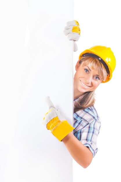 Female construction worker with blank board isolated on white