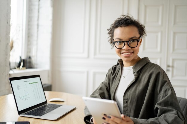 A female consultant uses a laptop to work in the office Coworking space company finance report