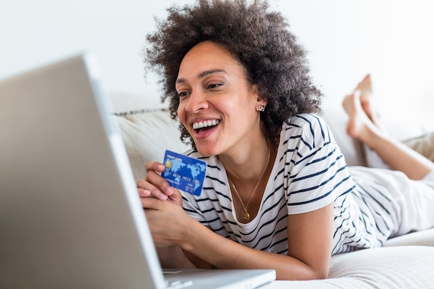 Female consumer spending buying on internet, lifestyle. Happy woman shopping online with laptop at home.