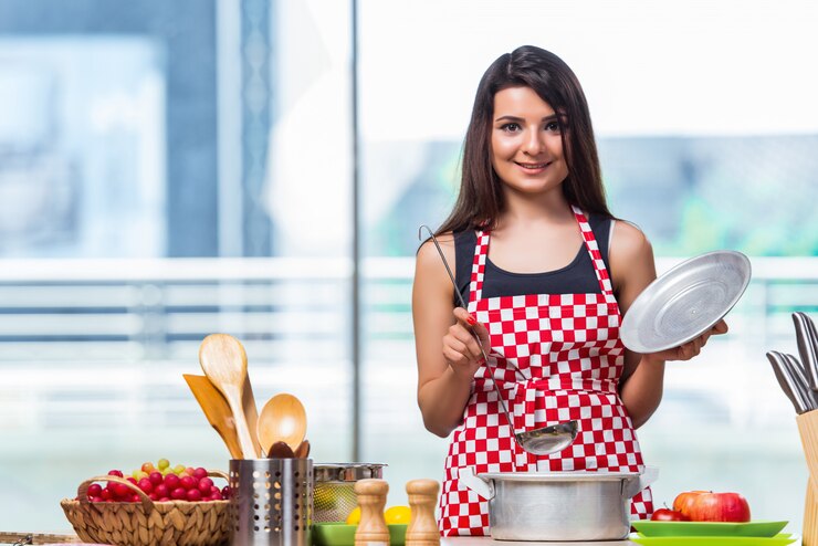 फोटो female cook preparing soup in brightly lit kitchen