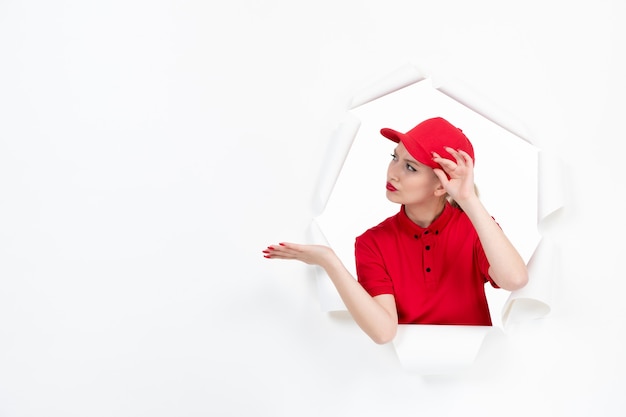 Female courier in red uniform on white