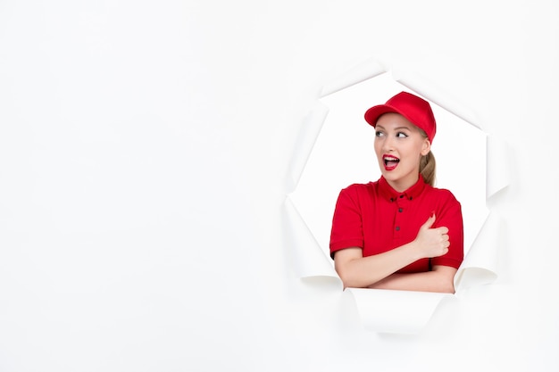 Female courier in red uniform on white