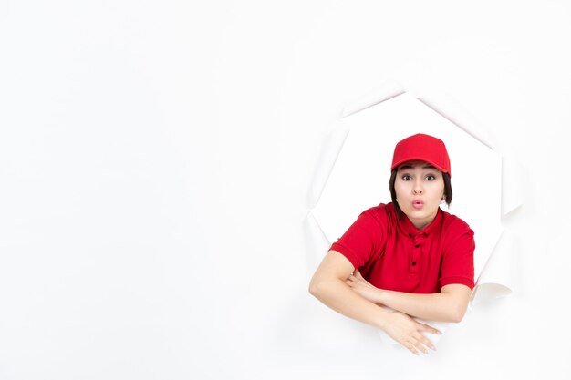 Female courier in red uniform on white