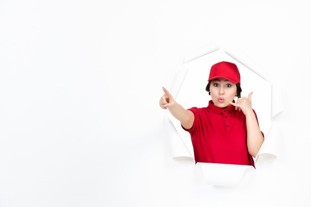 Female courier in red uniform on white