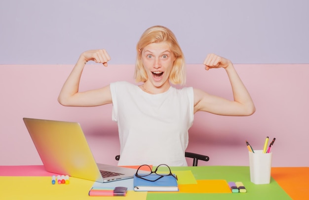 Female crazy fun student shows muscles woman power young\
teacher or tutor at classroom in school wom