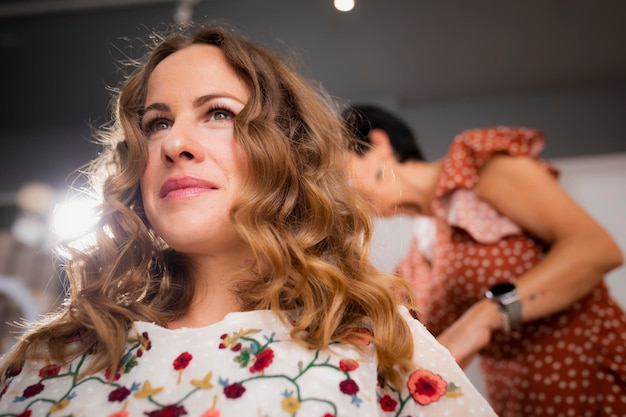 A female customer smiles during a hairdressing session at the hair salon