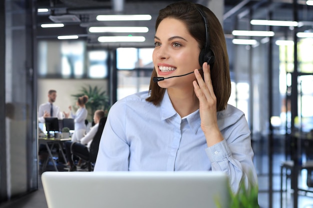 Female customer support operator with headset and smiling