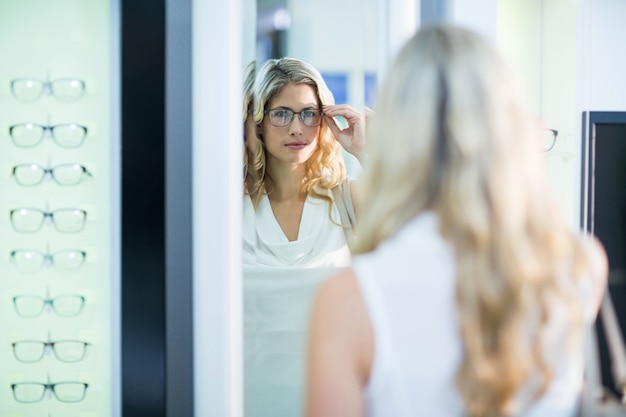 female customer trying spectacles