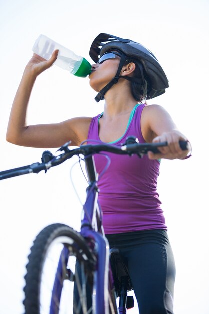 Female cyclist drinking water