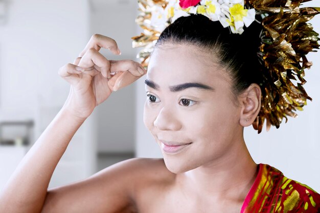 Female dancer applies powder in the makeup room