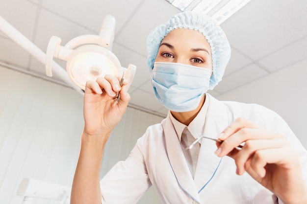 A female dentist examines a patient