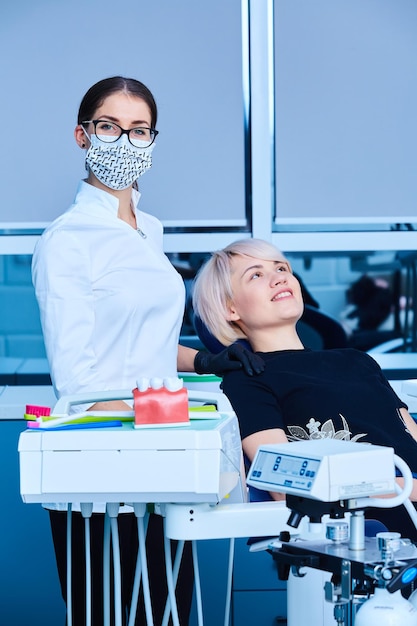 Female dentist examining a patient in the dental office for a woman