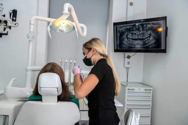 Female dentist examining a patient's teeth in the clinic. mouth hygiene