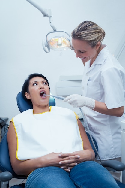 Female dentist examining womans teeth