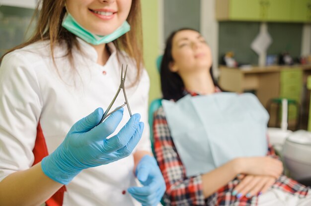 Female dentist holding dental tool. Orthodontic Treatment