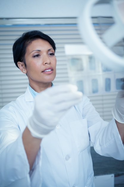 Female dentist looking at x-ray