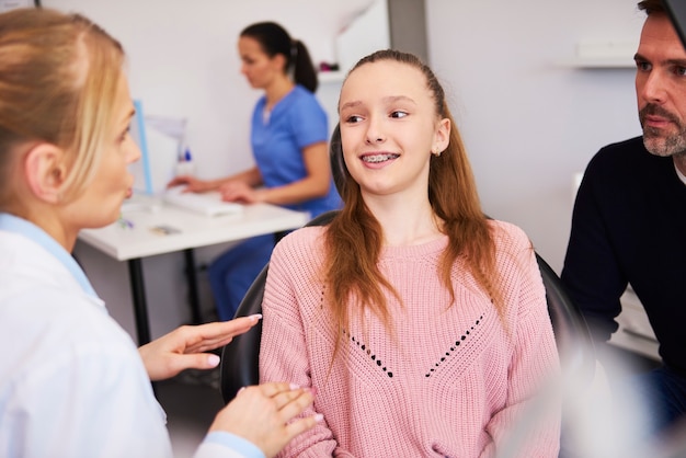 Female dentist and patient making a conversation