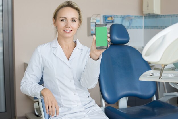 Female Dentist Presenting Mobile App