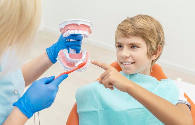 Female dentist showing her young patient