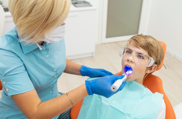 Female dentist using an ultraviolet dental