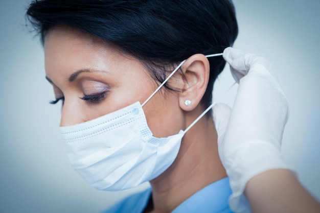 Female dentist wearing surgical mask