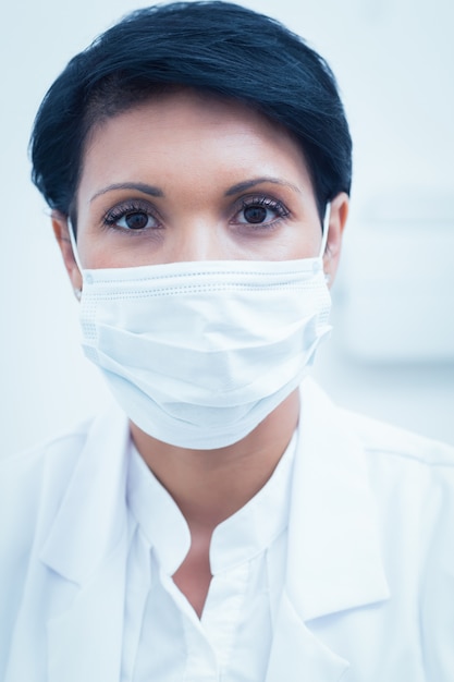 Female dentist wearing surgical mask