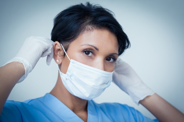 Female dentist wearing surgical mask