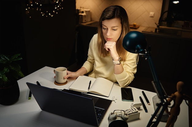 female designer working in home office at night