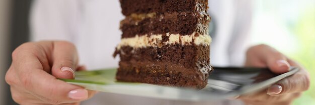 Female dietologist ask avoiding unhealthy sweet foods doctor holds big slice of chocolate cake