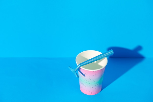 Female disposable razor in a cup, copy space