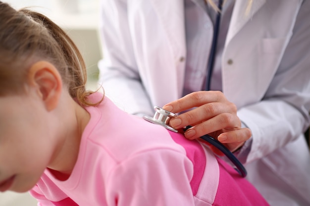 Female doctor arm hold stethoscope measuring patient heartbeat