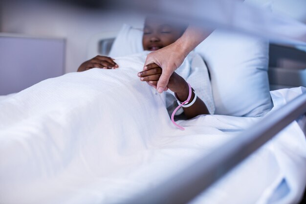 Female doctor checking patient fever in ward