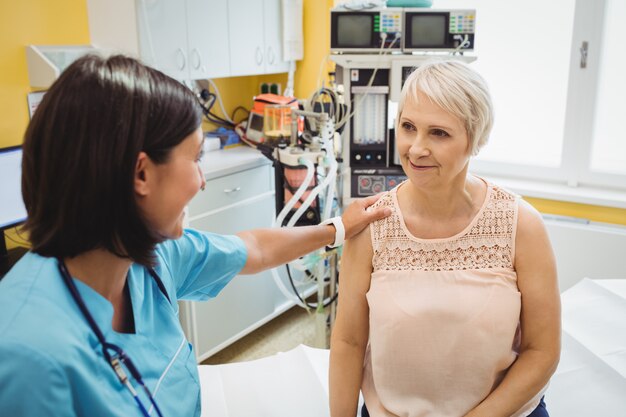 Female doctor consoling a patient