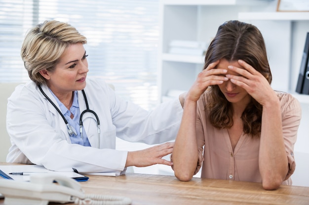 Female doctor consoling a patient