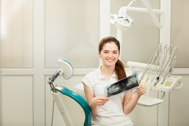 Female doctor or dentist looking at x-ray. Healthcare, medical and radiology concept