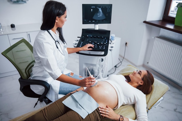 Female doctor does ultrasound for a pregnant woman in the hospital