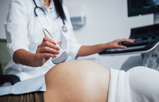 Female doctor does ultrasound for a pregnant woman in the hospital.