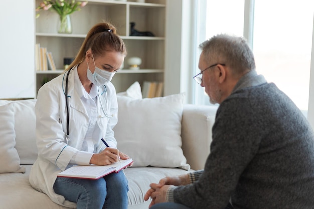 Female doctor examining older senior man in doctor office or at home old man patient and doctor have