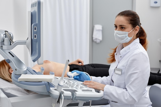 Female doctor examining patient in clinic